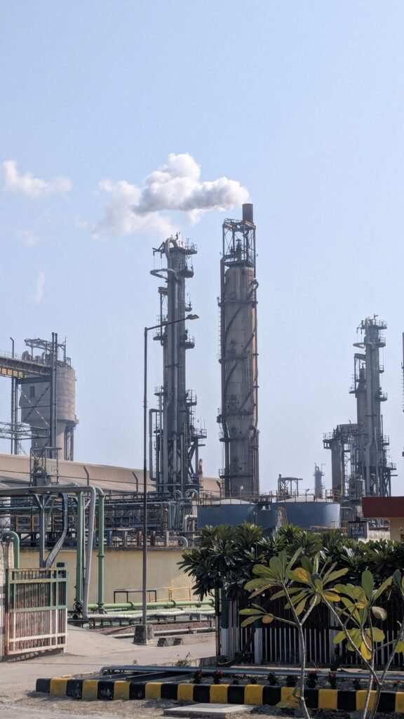 Chemical manufacturing plant with process towers against a clear sky